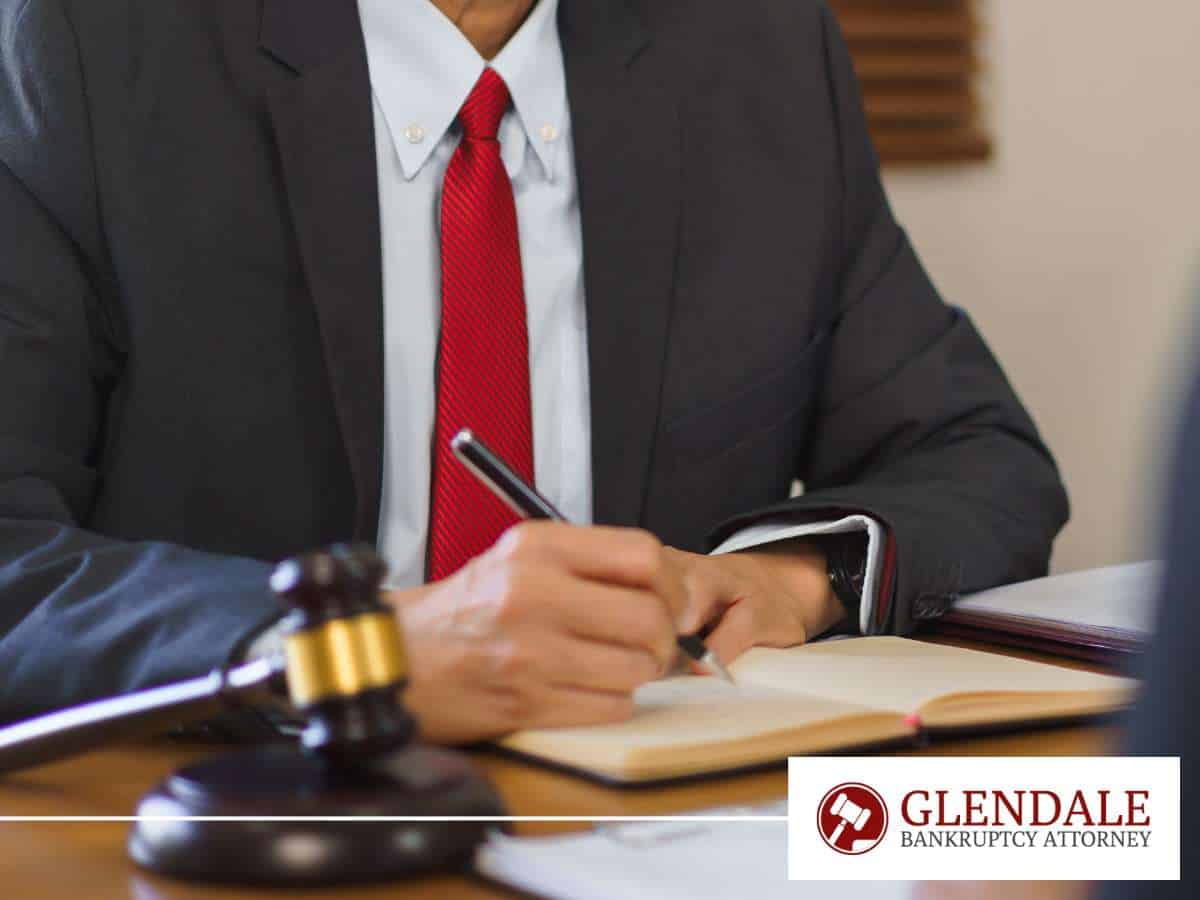 Bankruptcy attorney taking notes in office, addressing how sextortion can lead to bankruptcy