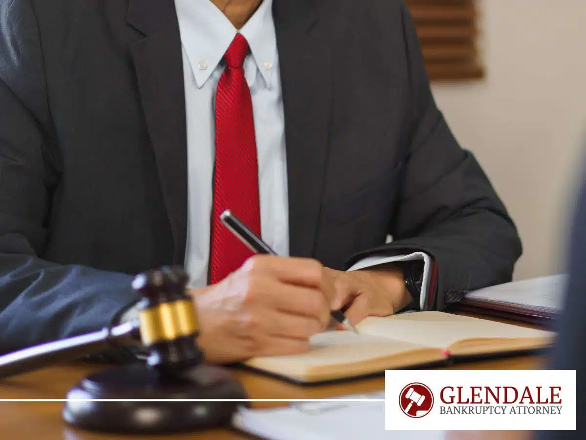 Bankruptcy attorney taking notes in office, addressing how sextortion can lead to bankruptcy